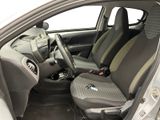 the interior of a small car with two seats and a steering wheel