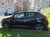 a small black car parked on the side of the street