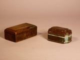 two small boxes sitting next to each other on a table