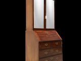 an old wooden bureau with a mirror on top of it