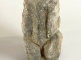statue of a bear sitting on a white surface
