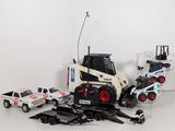 a toy truck and a toy car on a white surface