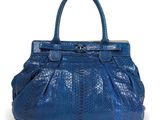 a close up of a blue handbag on a white background
