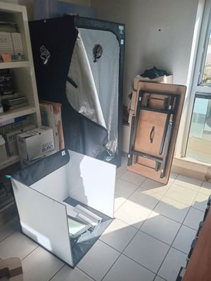 a refrigerator in the middle of a kitchen with a towel hanging from it ' s door