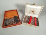 a lot of silver spoons in a box on the table
