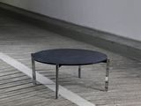 a black table sitting on a wooden floor in a room