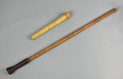 two wooden canes and a cane stick sitting on a table
