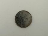 a small coin that is sitting on a white surface