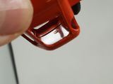 a person holding a small red object in their hand