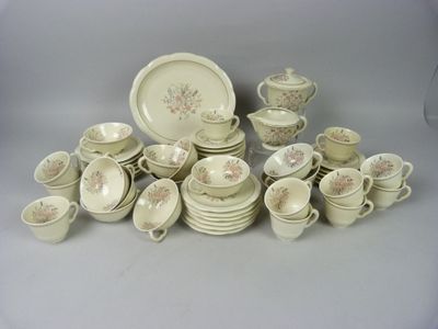 a lot of dishes and cups on the table