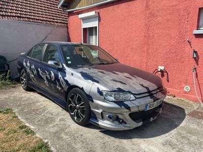 a picture of a car that is parked in front of a house