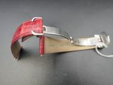 a red strap that is attached to a silver watch