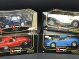 three toy cars are in boxes on a black surface