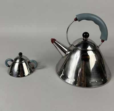 two tea kettles sitting next to each other on a table