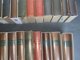 several books are stacked on top of each other on a table