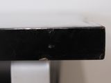 a close up of a black and white piece of furniture