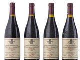 three bottles of wine are lined up on a white surface