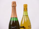 two bottles of wine sitting next to each other on a table