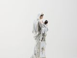 figurine of a woman holding a baby in her arms