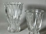 two glass vases sitting next to each other on a table