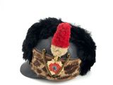 a stuffed animal wearing a hat with a chain around it
