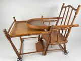 a wooden baby high chair with a tray on top of it