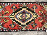 a close up of a rug on a floor with a tag on it