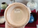 a person holding a cup with a sticker on it