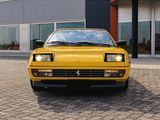 a yellow sports car parked in front of a building