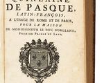 an old book with a coat of arms on top of it