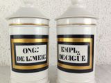 two white and gold canisters with black and white labels on them