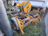 a machine that is sitting on the ground next to a truck