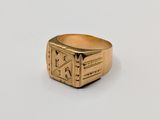 a close up of a gold ring on a white surface