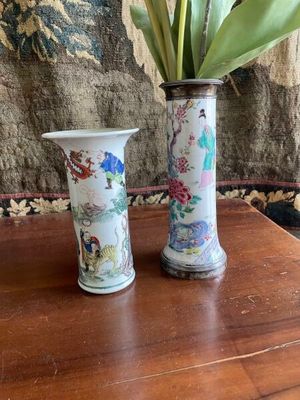 two vases that have flowers in them on a table