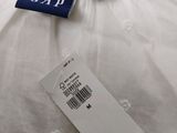 a close up of a white shirt with a tag on it