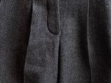 a close up of a person ' s pants hanging on a clothes rack