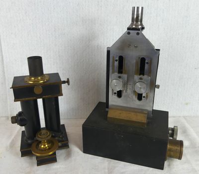 two different types of microscopes sitting on a table