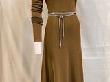 the dress is brown and has a belt around the waist
