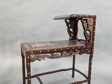 a small wooden bench with a wooden seat on it
