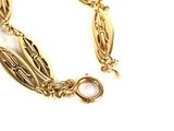 an image of a close up of a gold bracelet on a white background