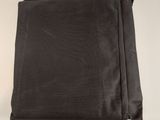 a close up of a black cloth on a white surface