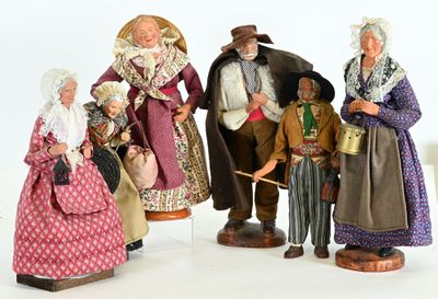 five figurines of people dressed in historical clothing