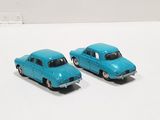 two toy cars that are sitting on a white surface