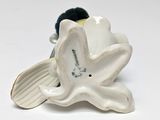 porcelain figurine of a white flower with a green leaf on it