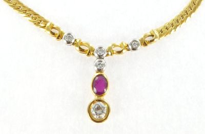 a close up of a necklace on a white surface