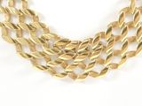 a close up of a gold necklace on a white background