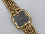a close up of a gold wrist watch with a black face