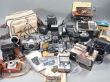 a lot of old cameras and other items on the table