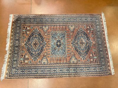 a rug on a wooden floor with a brown floor