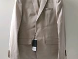 a suit hanging on a hanger on a wall